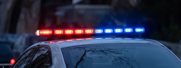 depositphotos_654420432-stock-photo-police-car-flashing-lights-nigh